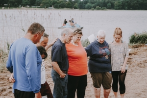 Members of the church praying before a baptism