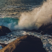 Waves crashing over large rocks.